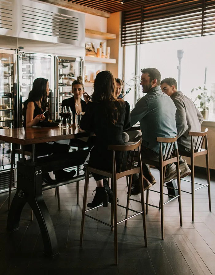 People sitting around high top table